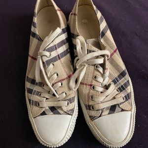 Burberry sneakers. Please see all photos. Puppy chewed back of one of sneakers.